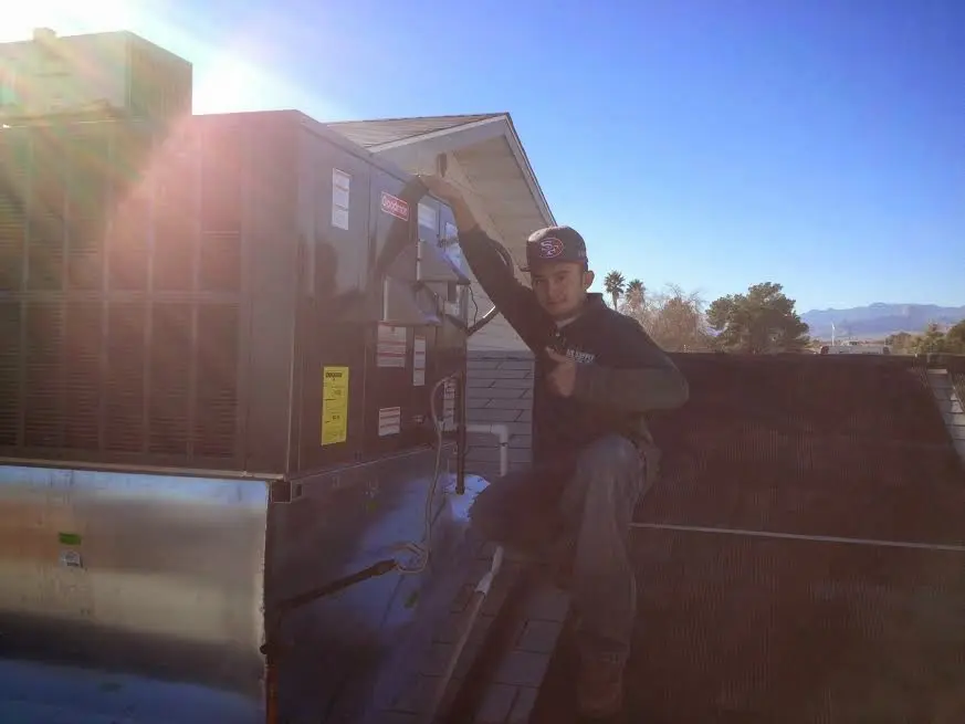 HVAC technician performing AC Tune-Up on a rooftop unit in East Hanover